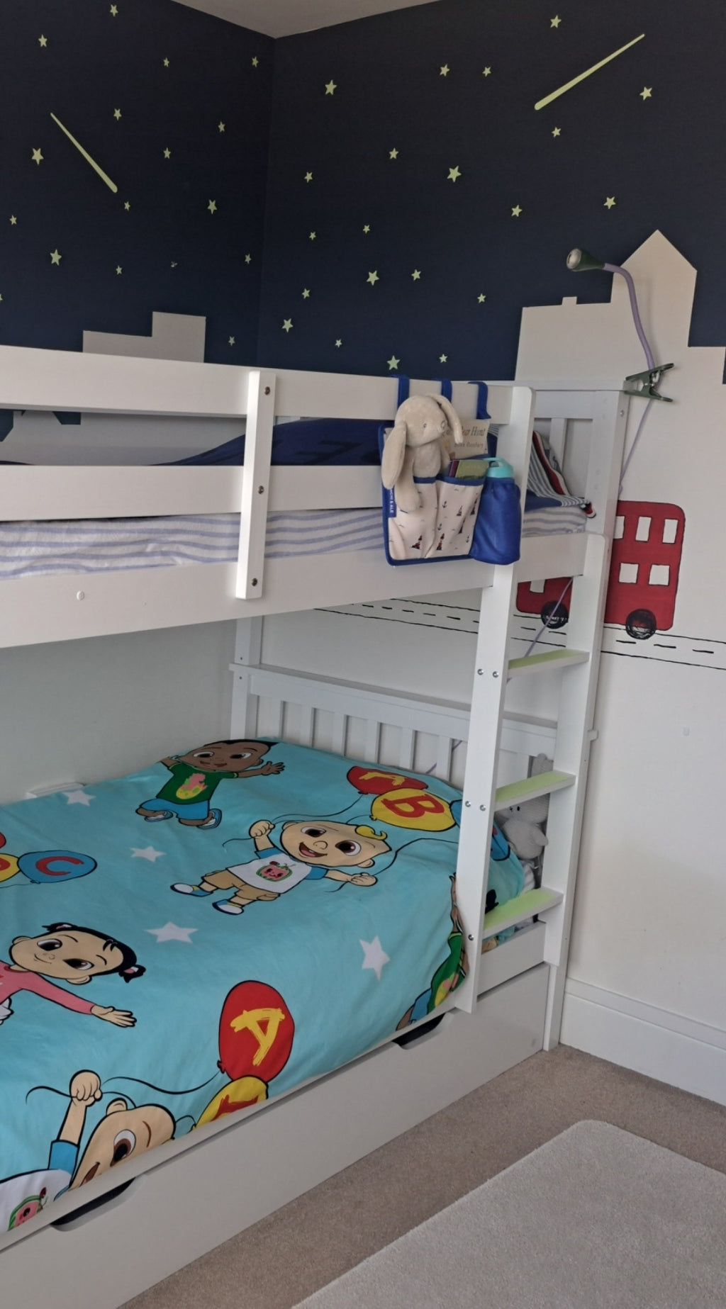 Franchi & Ale Bunk Bed Caddy hanging on a white bunk bed in a children's bedroom with nautical print fabric and royal blue trim